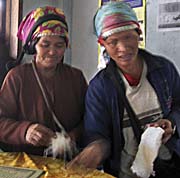 Akha Women selling Crafts in a Restaurant in Muang Sing by Asienreisender